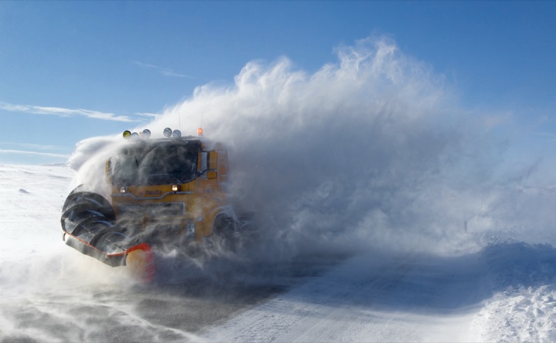 Snowplow clearing deep snow from the Saltfjellet mountain road in Norway
